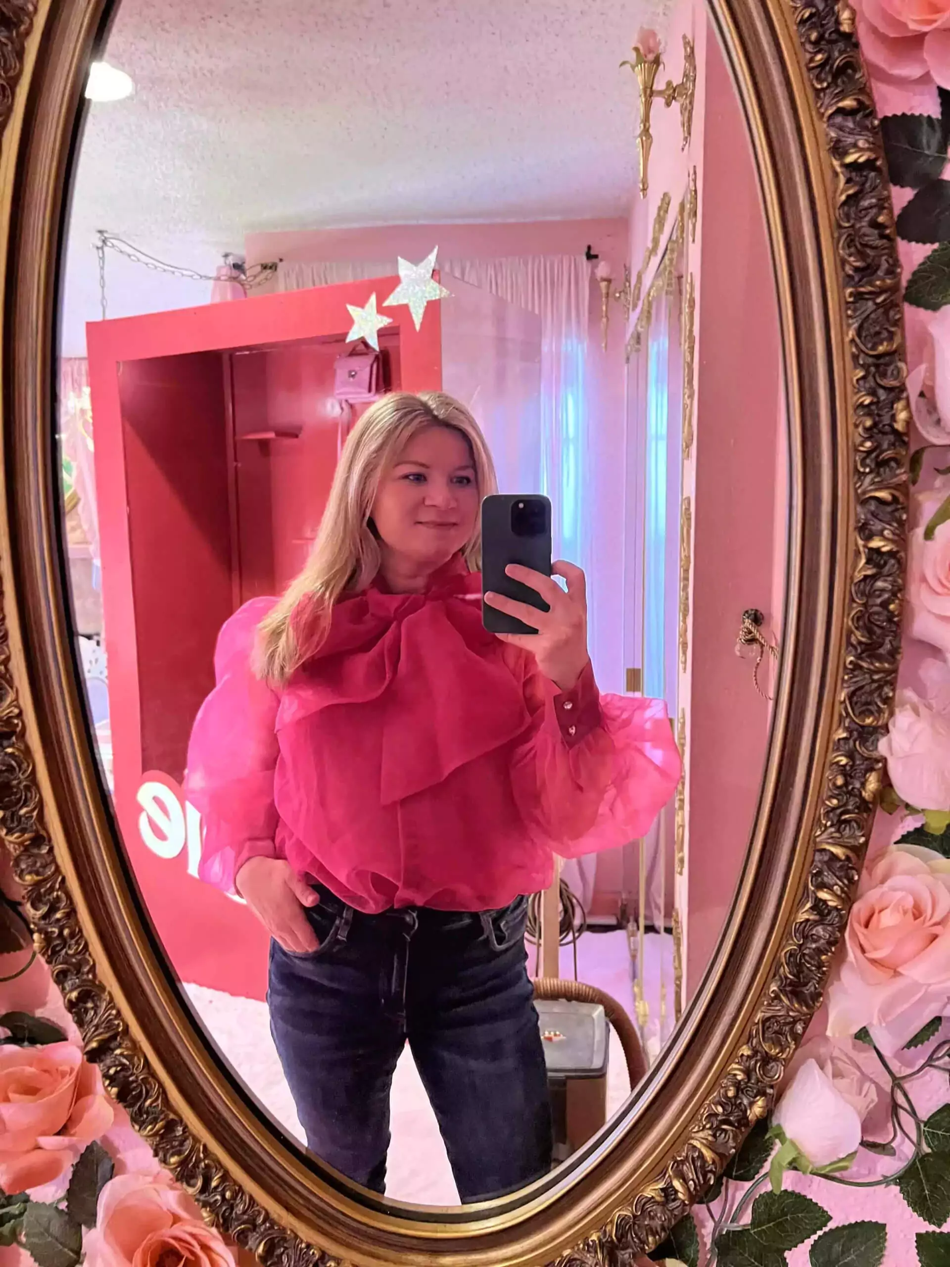 Katie selfie with hot pink top and jeans