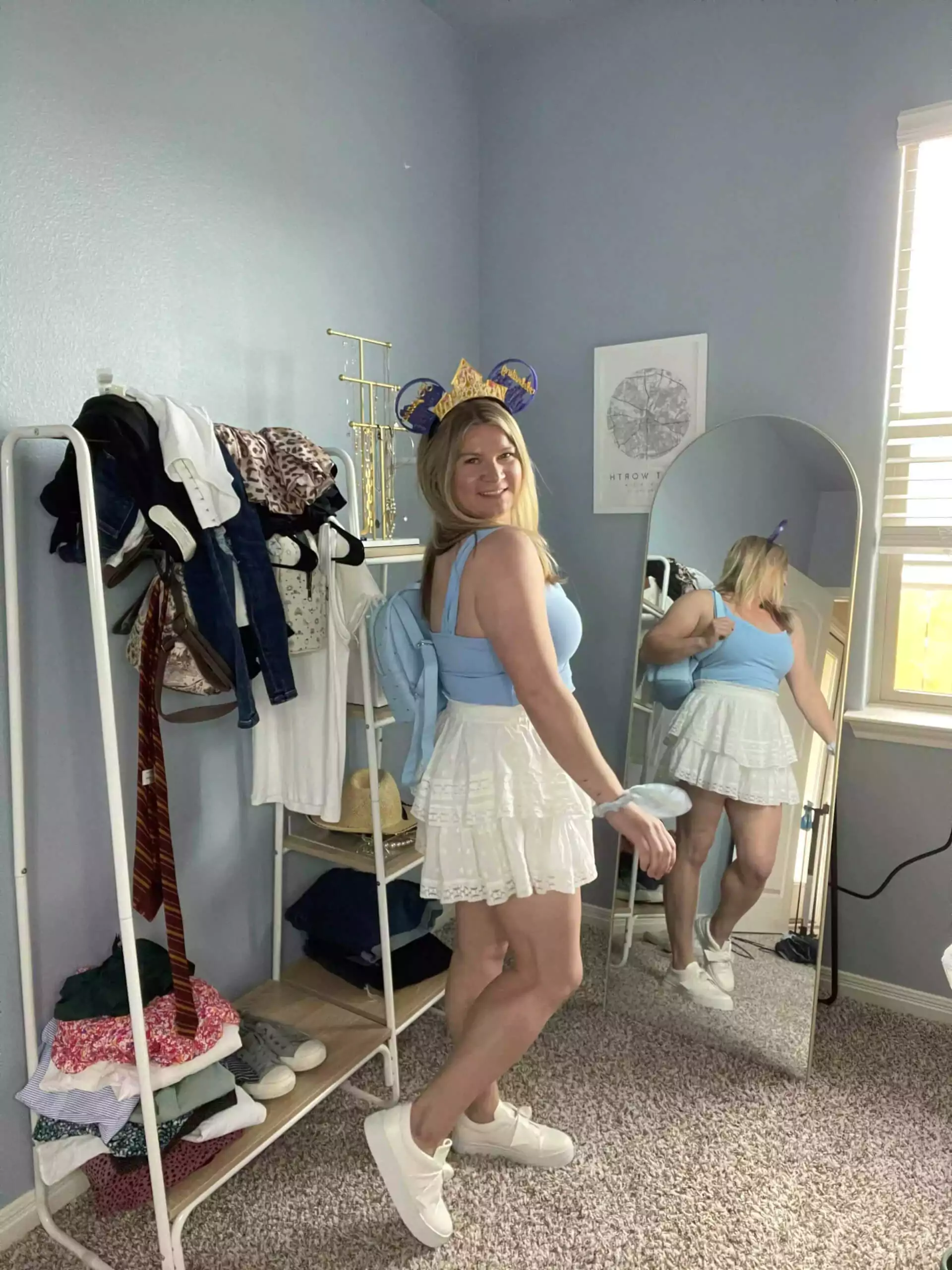 Katie wearing cute blue top and white skort outfit for Magic Kingdom for the ultimate Disney World packing list