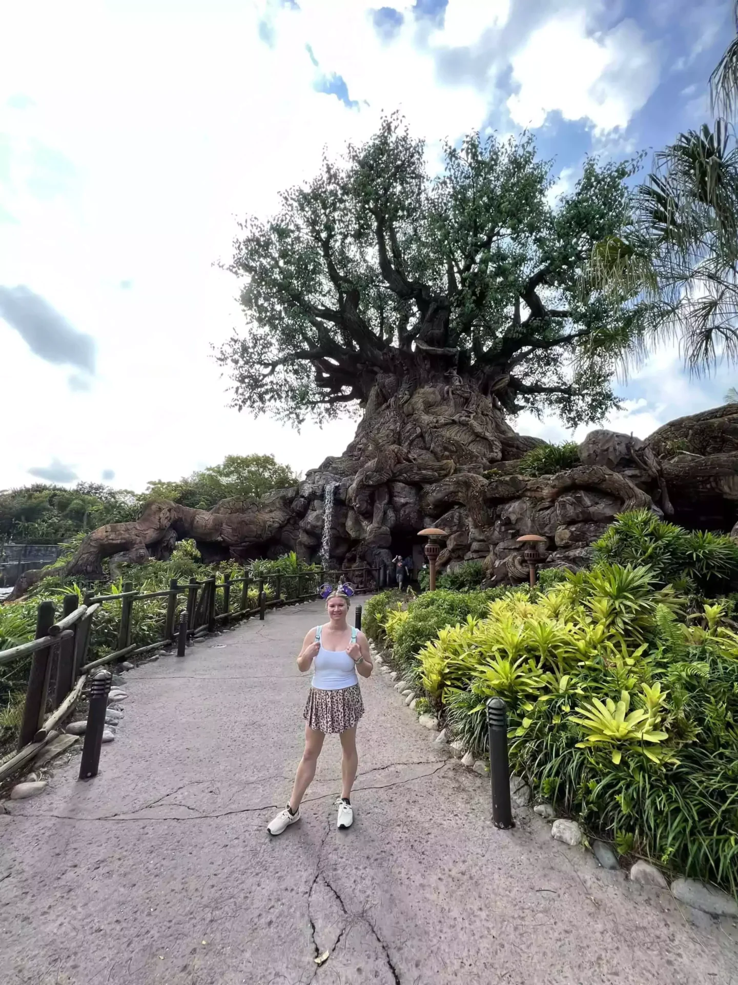 Katie wearing comfortable sneakers in front of the tree of life at animal kingdom theme park