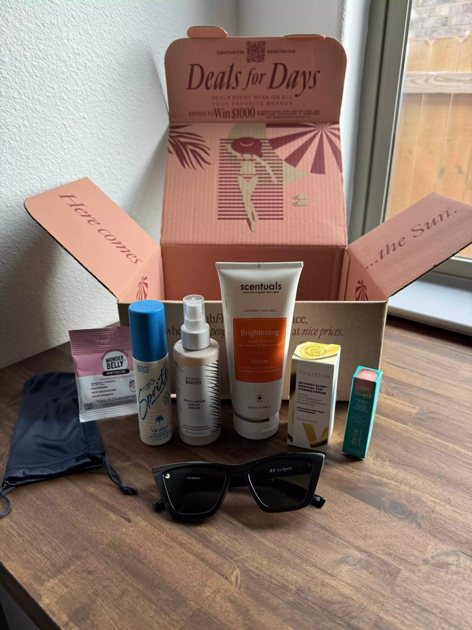FabFitFun Summer 2024 box displaying included items such as sunglasses, facial serum, and lip tint.