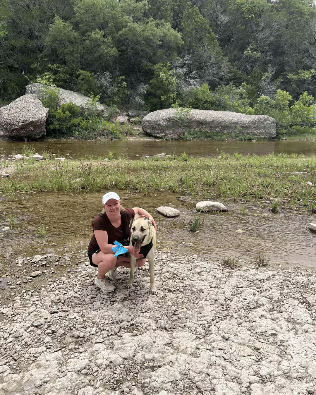 Katie in the river with dog Hank at dinosaur valley state park